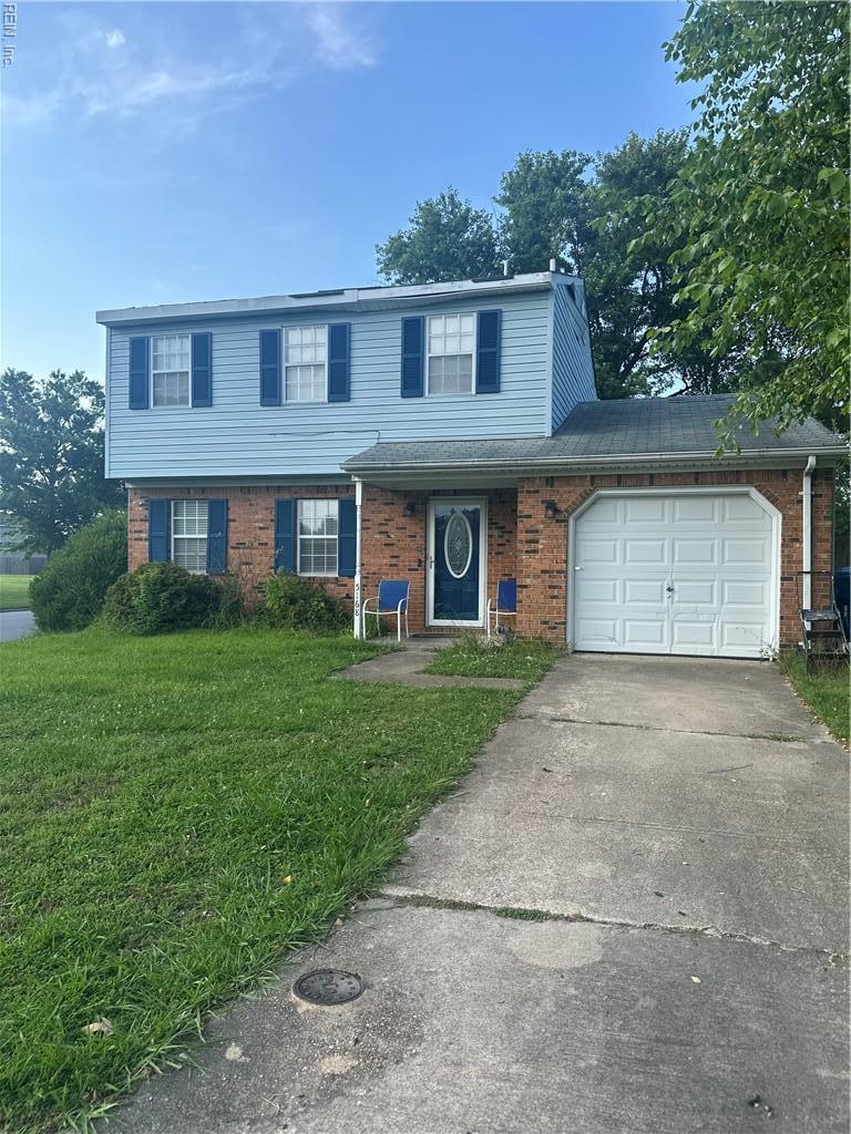 5168 Edon Hall Ln, Virginia Beach, VA 23464 - view of front of house with brick siding, a front lawn, an attached garage, and driveway