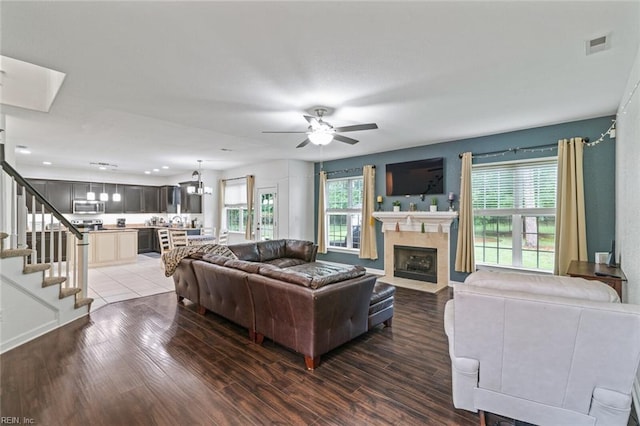 308 Queen Ct, Smithfield, VA 23430 - living room featuring ceiling fan, healthy amount of natural light, wood finished floors, and stairs