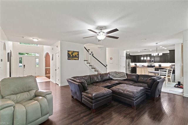 308 Queen Ct, Smithfield, VA 23430 - living area featuring dark wood finished floors, stairs, ceiling fan, a chandelier, and arched walkways