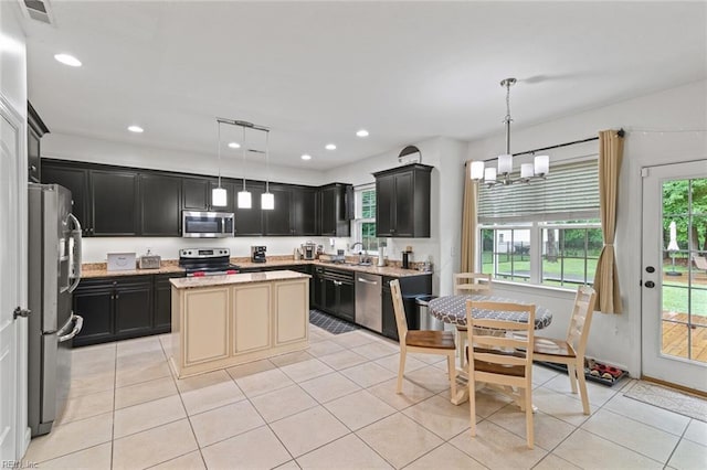 308 Queen Ct, Smithfield, VA 23430 - kitchen featuring stainless steel appliances, healthy amount of natural light, dark cabinetry, light tile patterned flooring, and recessed lighting