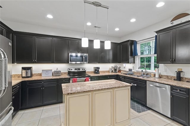 308 Queen Ct, Smithfield, VA 23430 - kitchen with appliances with stainless steel finishes, dark cabinetry, light tile patterned floors, light stone countertops, and recessed lighting