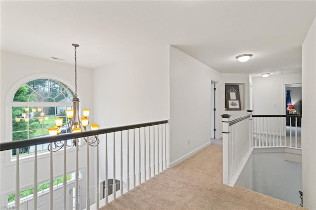 308 Queen Ct, Smithfield, VA 23430 - corridor featuring a chandelier, carpet, and an upstairs landing
