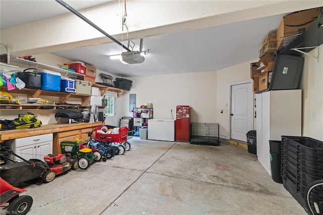 308 Queen Ct, Smithfield, VA 23430 - garage with refrigerator, a garage door opener, and electric panel