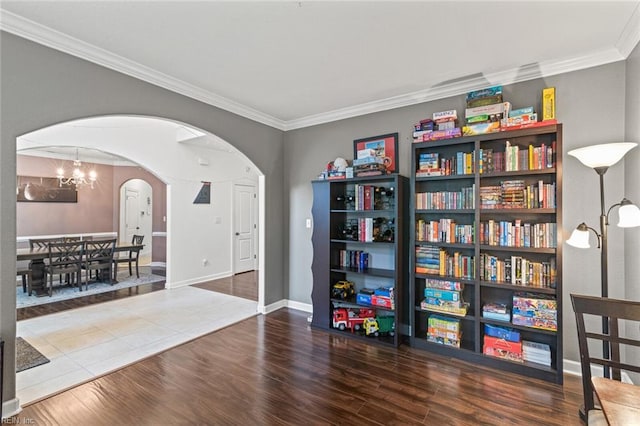 308 Queen Ct, Smithfield, VA 23430 - living area featuring arched walkways, ornamental molding, wood finished floors, and a chandelier