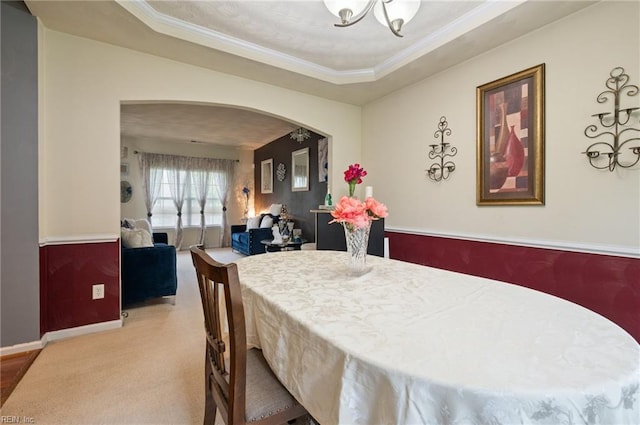2559 Golden Maple Dr, Suffolk, VA 23434 - carpeted dining space with arched walkways, a chandelier, a tray ceiling, and crown molding