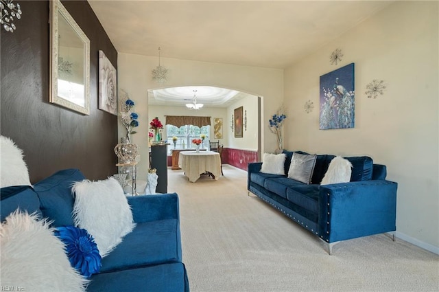 2559 Golden Maple Dr, Suffolk, VA 23434 - carpeted living room featuring a chandelier and arched walkways