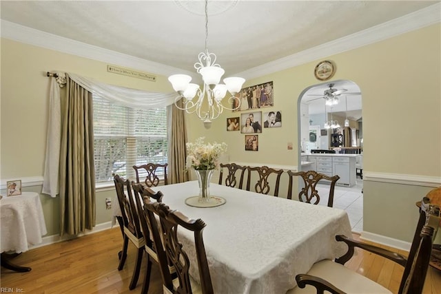 3644 Brannon Dr, Virginia Beach, VA 23456 - dining space featuring a chandelier, crown molding, light wood-type flooring, and arched walkways