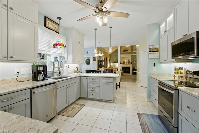 3644 Brannon Dr, Virginia Beach, VA 23456 - kitchen with stainless steel appliances, ceiling fan, a peninsula, light tile patterned floors, and pendant lighting