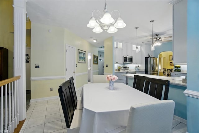 3644 Brannon Dr, Virginia Beach, VA 23456 - dining room with light tile patterned floors, a chandelier, a ceiling fan, and arched walkways