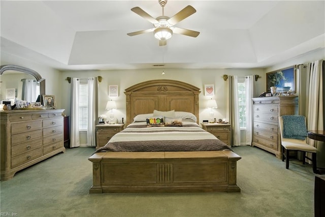3644 Brannon Dr, Virginia Beach, VA 23456 - bedroom with a tray ceiling, light carpet, multiple windows, and ceiling fan