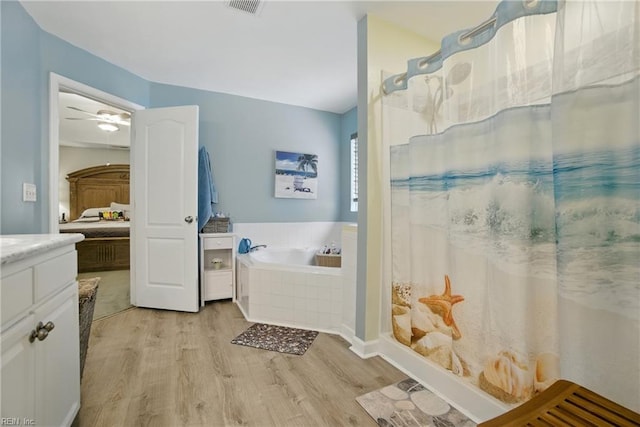 3644 Brannon Dr, Virginia Beach, VA 23456 - full bathroom with wood finished floors, a garden tub, vanity, a ceiling fan, and curtained shower