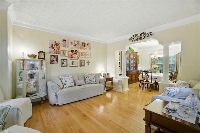 3644 Brannon Dr, Virginia Beach, VA 23456 - living room with decorative columns, light wood finished floors, ornamental molding, and a chandelier