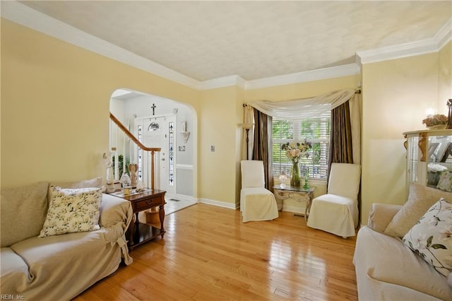3644 Brannon Dr, Virginia Beach, VA 23456 - living room featuring arched walkways, light wood finished floors, stairway, and crown molding