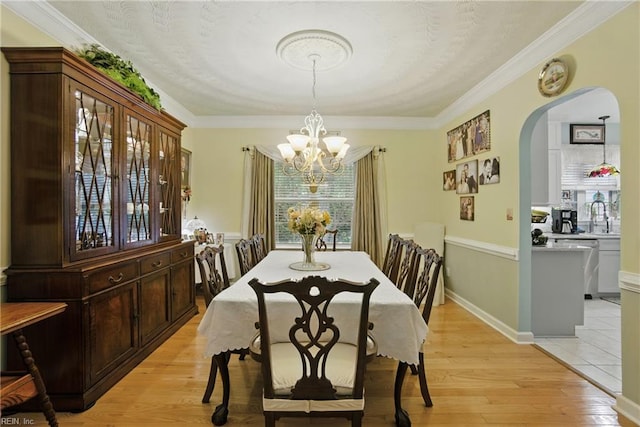 3644 Brannon Dr, Virginia Beach, VA 23456 - dining room featuring arched walkways, a chandelier, light wood-style flooring, and crown molding