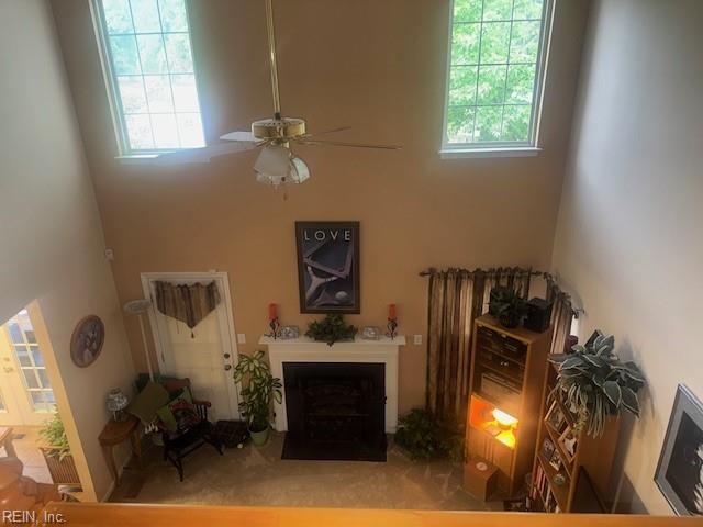 203 Lentz Pl, Newport News, VA 23602 - living room featuring a towering ceiling, a ceiling fan, and a fireplace with flush hearth