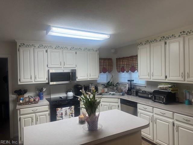 203 Lentz Pl, Newport News, VA 23602 - kitchen featuring stainless steel appliances, white cabinetry, light countertops, and a center island