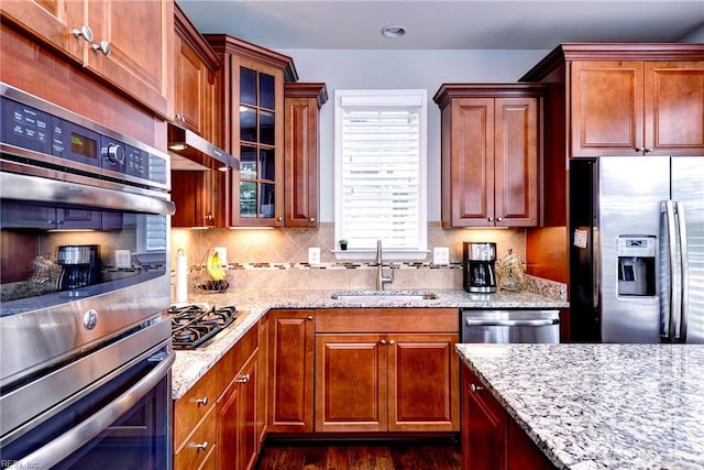 6355 Cordelia Rd, Williamsburg, VA 23188 - kitchen featuring appliances with stainless steel finishes, light stone counters, glass insert cabinets, backsplash, and under cabinet range hood