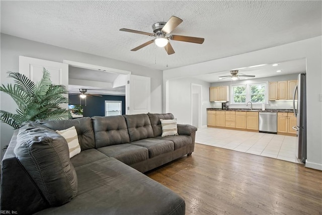 1505 Hawthorne Dr, Chesapeake, VA 23325 - living room featuring a ceiling fan, light wood-style floors, and a textured ceiling
