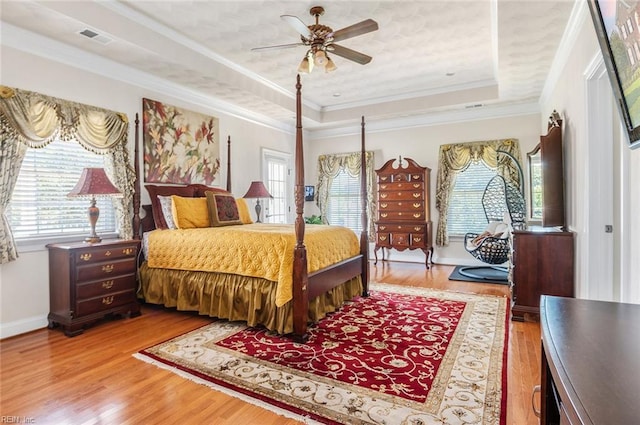 3033 N James Dr, Suffolk, VA 23435 - bedroom with a raised ceiling, wood finished floors, ornamental molding, and a ceiling fan