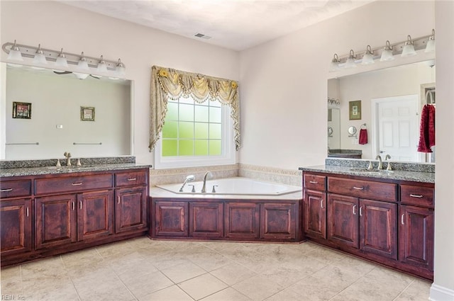 3033 N James Dr, Suffolk, VA 23435 - full bathroom featuring two vanities, a bath, and tile patterned flooring
