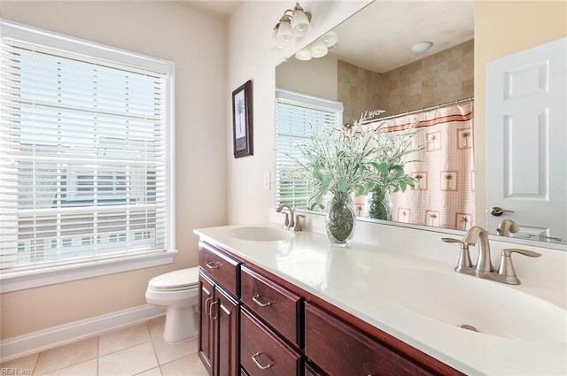 3033 N James Dr, Suffolk, VA 23435 - full bath with double vanity, healthy amount of natural light, tile patterned flooring, and a shower with shower curtain