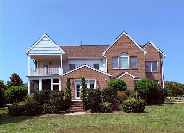3033 N James Dr, Suffolk, VA 23435 - view of front facade featuring a balcony, brick siding, and a front yard