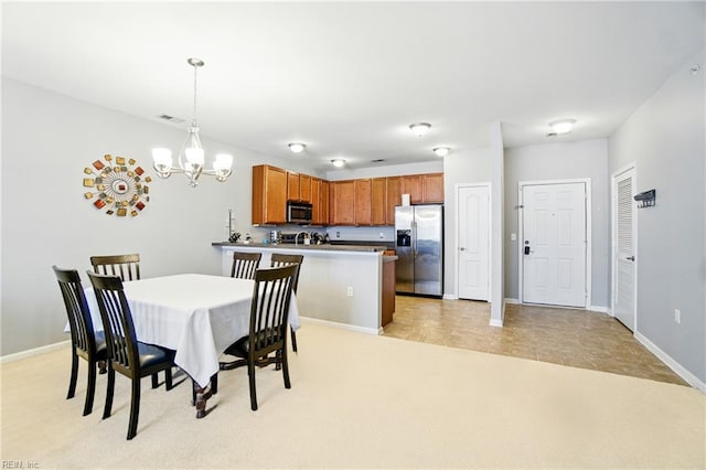924 Southmoor Dr Unit 204, Virginia Beach, VA 23455 - dining area featuring a chandelier and light colored carpet