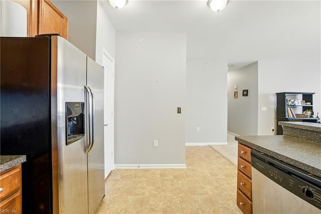 924 Southmoor Dr Unit 204, Virginia Beach, VA 23455 - kitchen featuring appliances with stainless steel finishes, dark countertops, and brown cabinetry