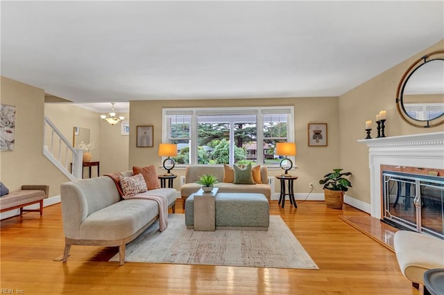 241 Sir Oliver Rd, Norfolk, VA 23505 - living area featuring light wood finished floors, stairway, a chandelier, and a premium fireplace