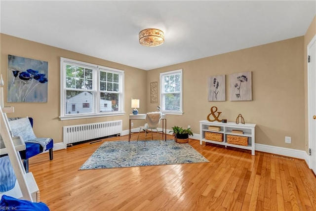 241 Sir Oliver Rd, Norfolk, VA 23505 - living area featuring radiator, light wood finished floors, and plenty of natural light