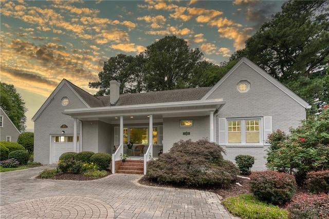 241 Sir Oliver Rd, Norfolk, VA 23505 - shingle-style home with brick siding, covered porch, a chimney, and decorative driveway