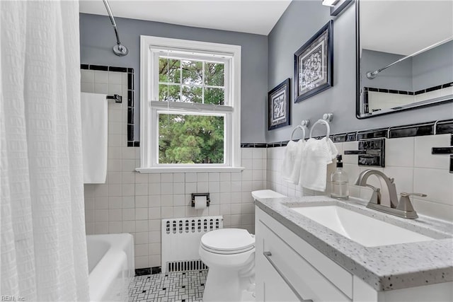 241 Sir Oliver Rd, Norfolk, VA 23505 - full bath featuring radiator heating unit, tile walls, vanity, tile patterned flooring, and shower / bath combo