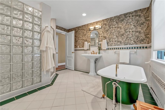 241 Sir Oliver Rd, Norfolk, VA 23505 - full bath with radiator, tile patterned flooring, tile walls, a soaking tub, and wainscoting