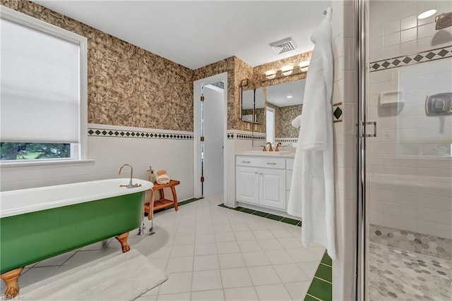 241 Sir Oliver Rd, Norfolk, VA 23505 - bathroom featuring a freestanding bath, vanity, a stall shower, a wainscoted wall, and wallpapered walls