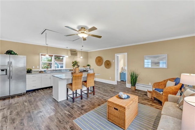 241 Sir Oliver Rd, Norfolk, VA 23505 - living area featuring a wall mounted air conditioner, ceiling fan, ornamental molding, dark wood-type flooring, and attic access
