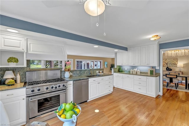 241 Sir Oliver Rd, Norfolk, VA 23505 - kitchen featuring stainless steel appliances, white cabinetry, decorative backsplash, recessed lighting, and crown molding