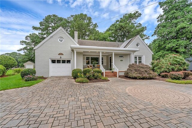 241 Sir Oliver Rd, Norfolk, VA 23505 - view of front facade featuring curved driveway, a porch, a chimney, and brick siding