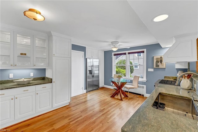 241 Sir Oliver Rd, Norfolk, VA 23505 - kitchen with stainless steel refrigerator with ice dispenser, radiator heating unit, white cabinetry, and light wood-style floors