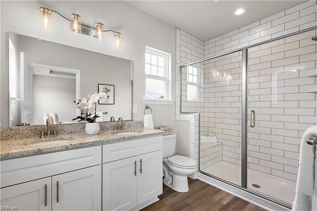 1015 Hillpoint Rd, Suffolk, VA 23434 - bathroom with double vanity, a stall shower, and wood finished floors