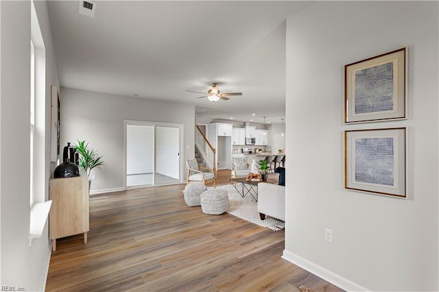 1015 Hillpoint Rd, Suffolk, VA 23434 - living room featuring stairs, light wood-type flooring, and ceiling fan
