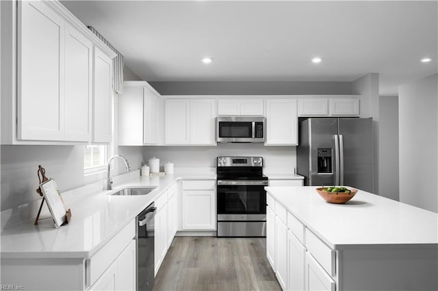 3617 Clyde St, Elizabeth City, NC 27909 - kitchen with stainless steel appliances, light wood-style floors, recessed lighting, light countertops, and white cabinets