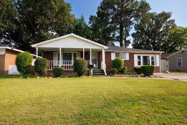 565 River Creek Rd, Chesapeake, VA 23320 - view of front of house with brick siding, a porch, and a front yard