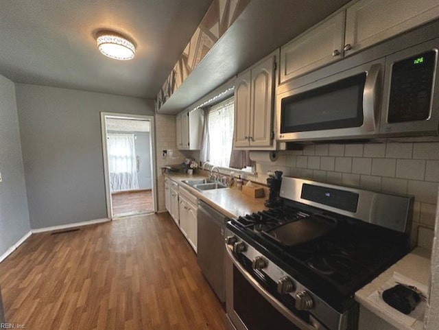 565 River Creek Rd, Chesapeake, VA 23320 - kitchen with appliances with stainless steel finishes, backsplash, dark wood-type flooring, white cabinets, and light countertops