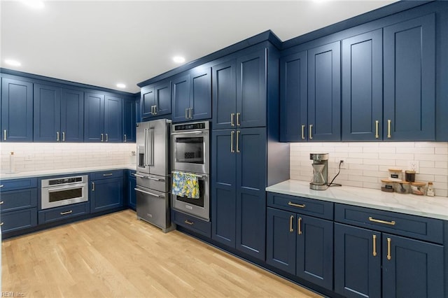 6070 Newport Pt, Norfolk, VA 23505 - kitchen with stainless steel appliances, blue cabinetry, tasteful backsplash, light wood-type flooring, and recessed lighting
