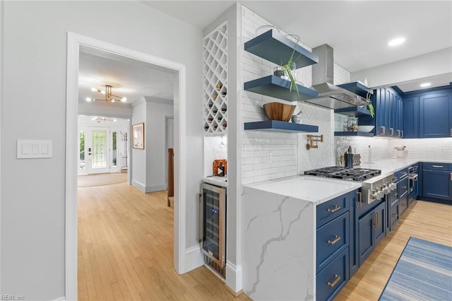 6070 Newport Pt, Norfolk, VA 23505 - kitchen with blue cabinetry, beverage cooler, stainless steel gas cooktop, open shelves, and tasteful backsplash