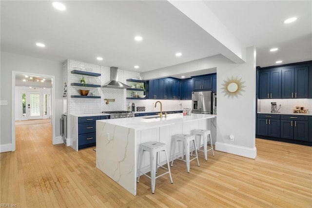 6070 Newport Pt, Norfolk, VA 23505 - kitchen with stainless steel appliances, blue cabinets, open shelves, wall chimney exhaust hood, and recessed lighting