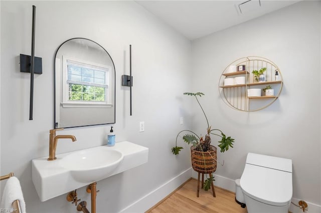6070 Newport Pt, Norfolk, VA 23505 - half bath with wood finished floors and toilet