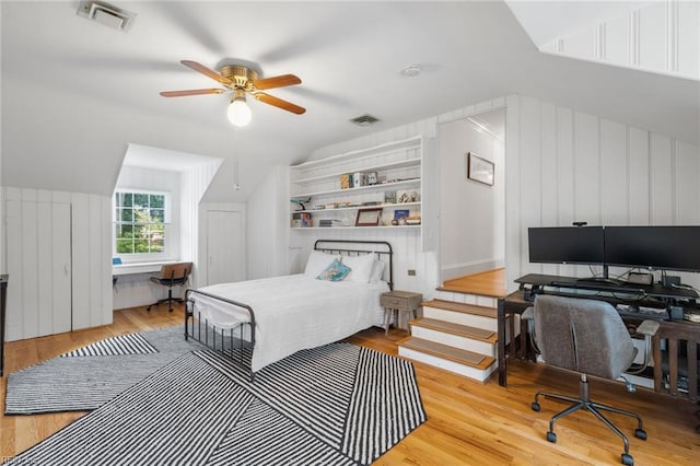 6070 Newport Pt, Norfolk, VA 23505 - bedroom featuring an office area, wood finished floors, vaulted ceiling, a ceiling fan, and a decorative wall