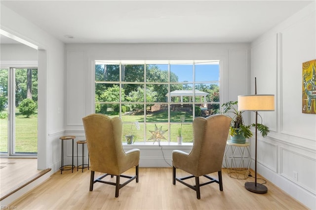 6070 Newport Pt, Norfolk, VA 23505 - sitting room with light wood-type flooring, a decorative wall, and plenty of natural light