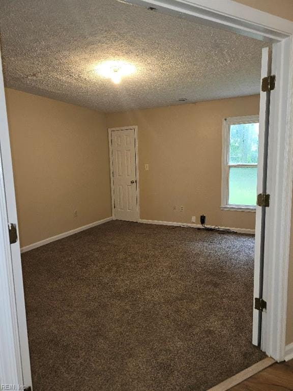 238 Susan Constant Dr, Newport News, VA 23608 - empty room with a textured ceiling and dark colored carpet